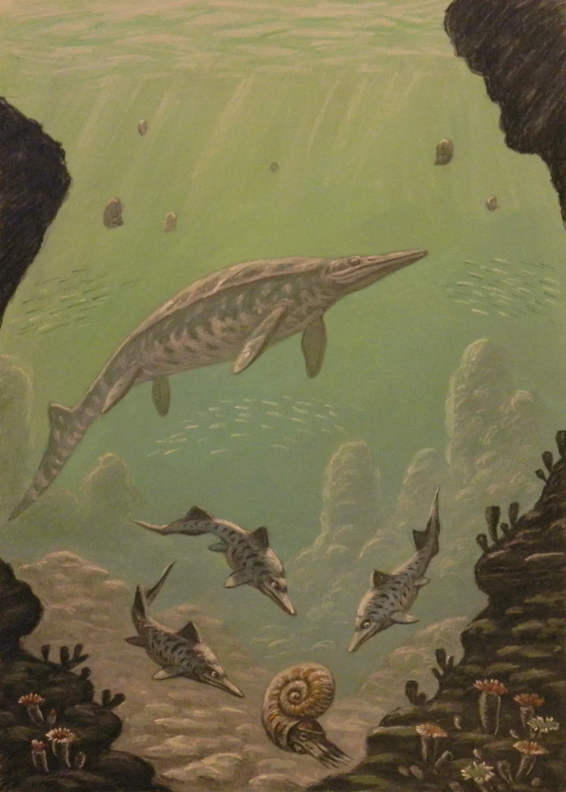 Marine reptiles swim through a vertical underwater scene among rocks and ammonites.